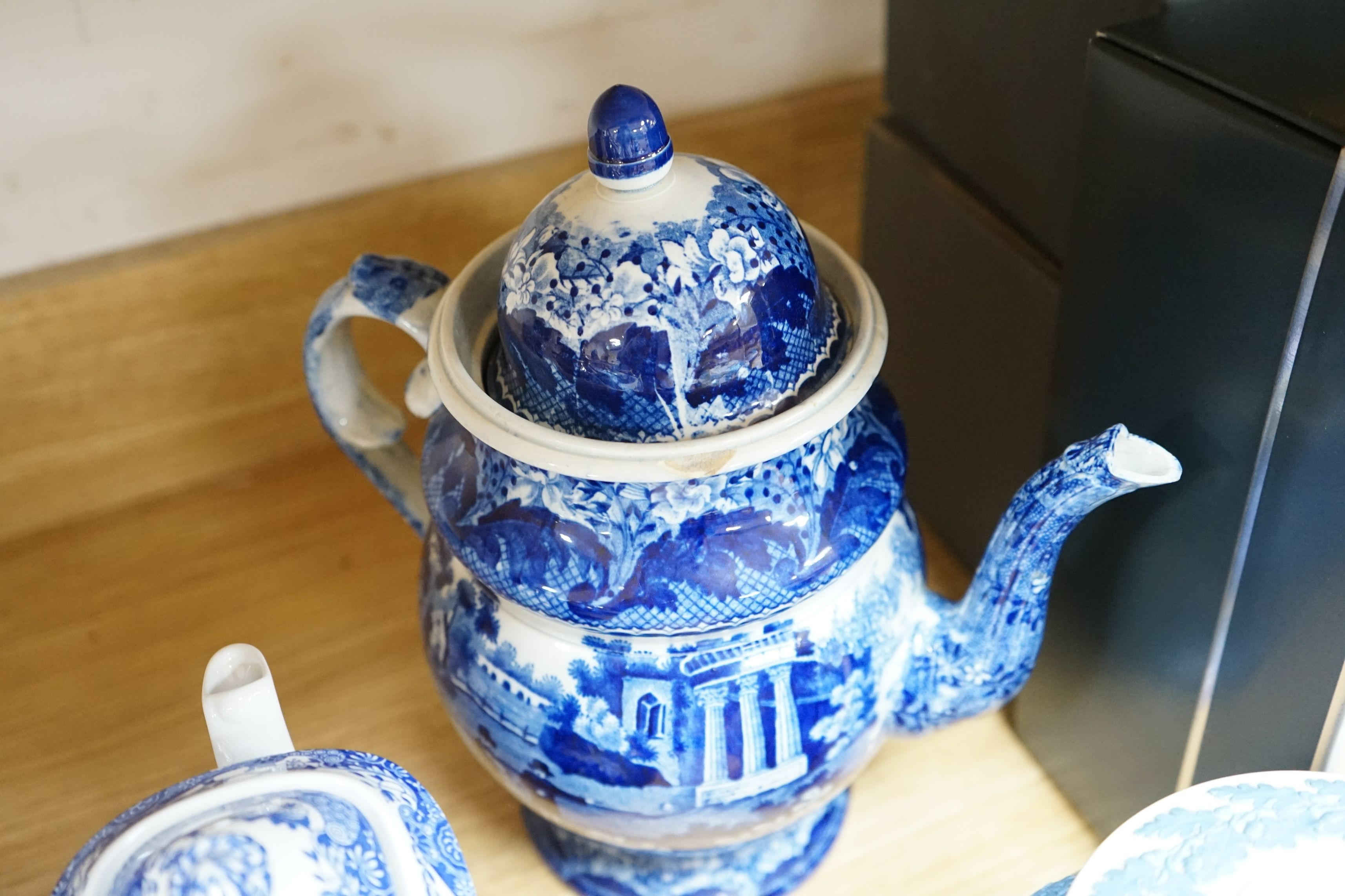 An early 19th century pearlware blue and white tea pot, two others and a Wedgwood style teapot, tallest 30cms high
